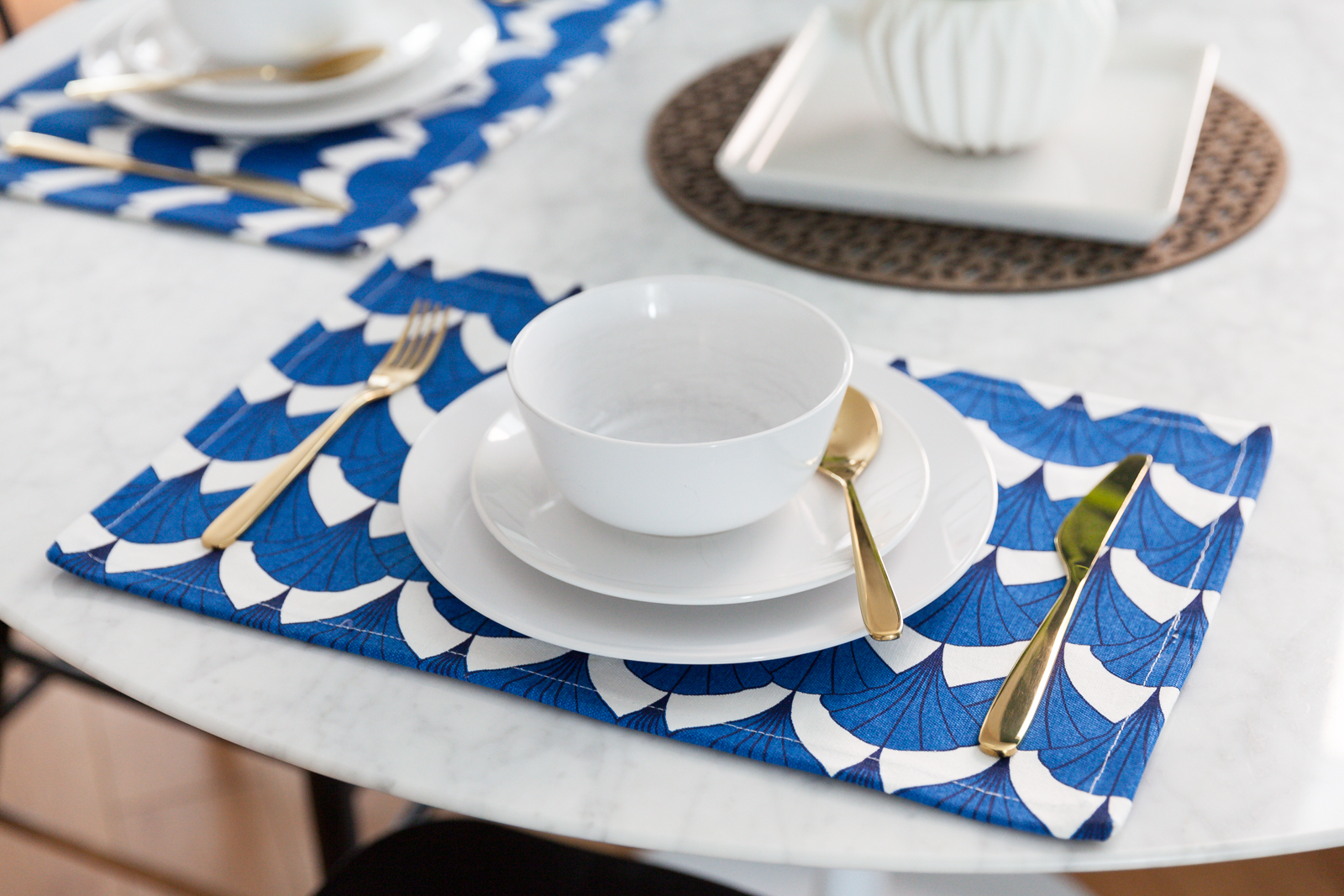 A bold white and blue placemat on a kitchen table