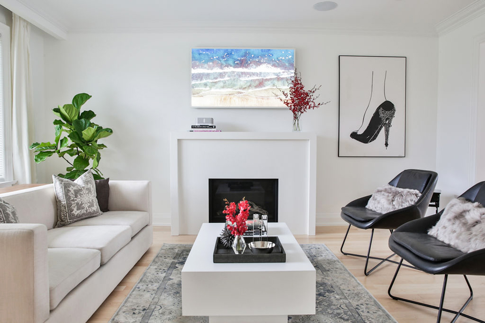 A pristine white monochromatic living room with minimalist decor