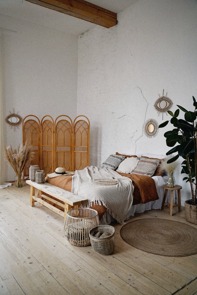 cozy boho bedroom with orange, brown and white bedding