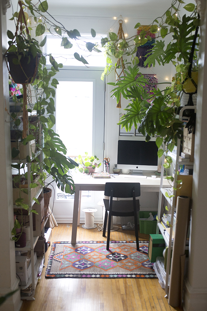white home office with hanging green plants