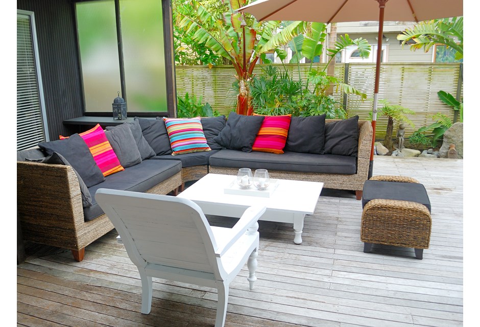 Patio furniture, including a couch with overheard umbrella