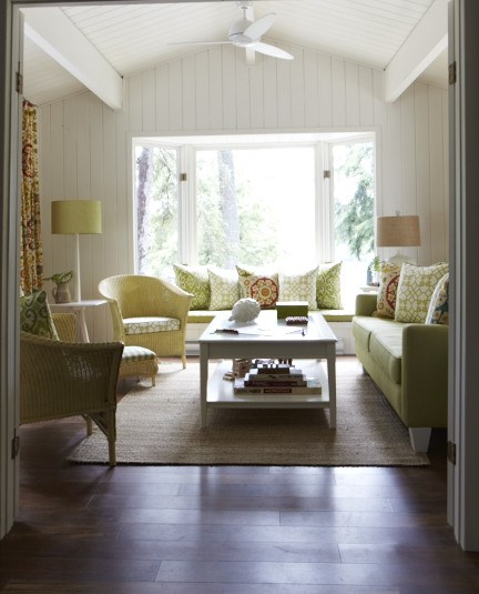 A bright and airy sun room in a cottage with pastel colours
