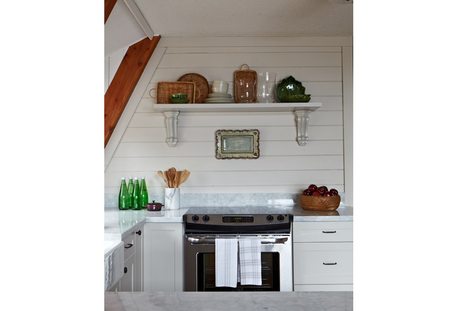 A cozy cottage kitchen with floating shelves containing family heirlooms