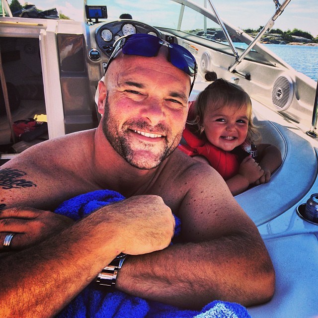 Bryan hanging out with his youngest daughter JoJo on a boat.
