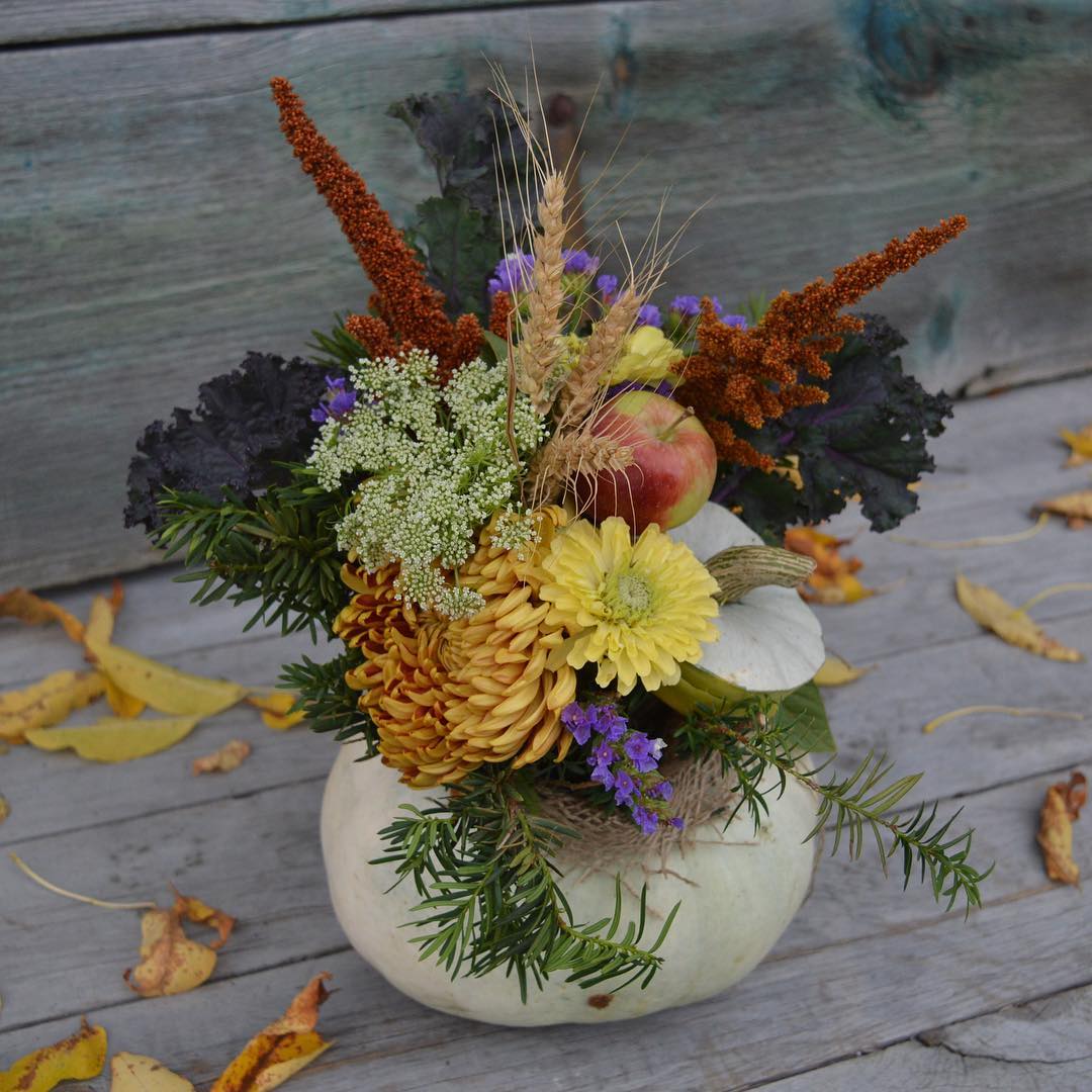 Pumpkin-themed autumn floral arrangement