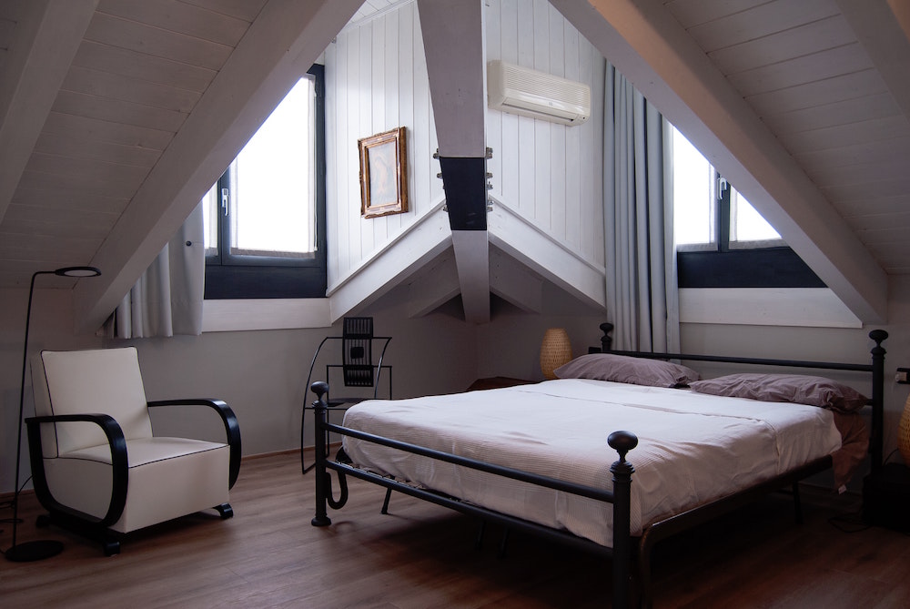 small white attic room with black accents