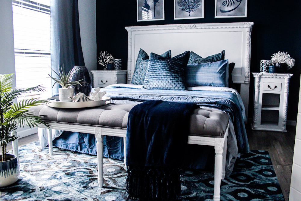 blue bedroom with bright white furniture and trims