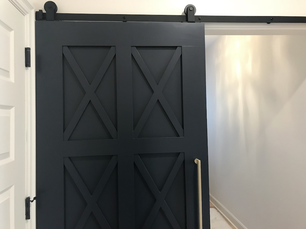 black barn door in white room