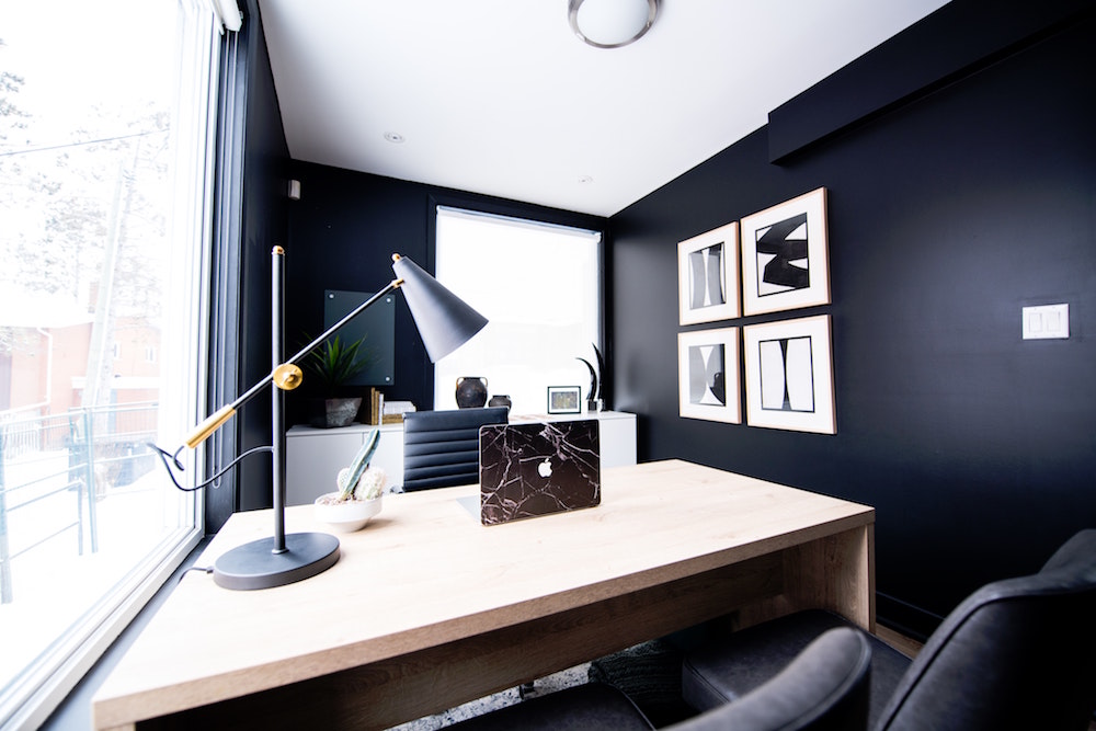 office with black walls and light desk