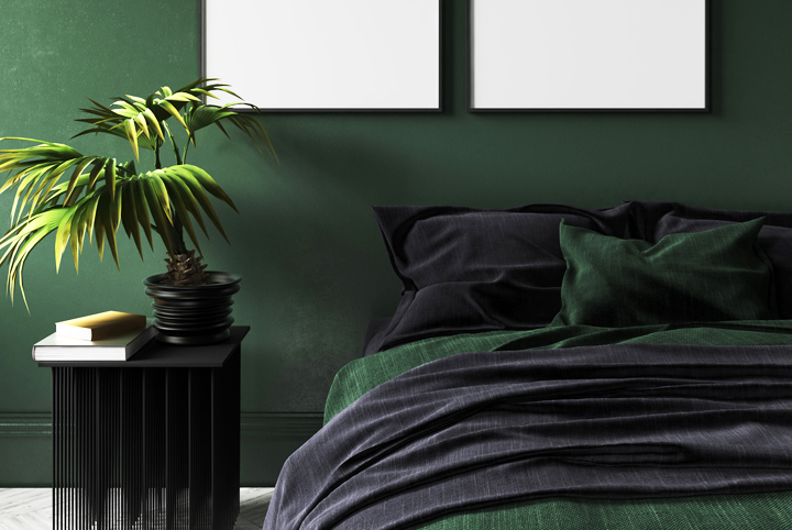 bedroom with dark forest green walls and green sheets