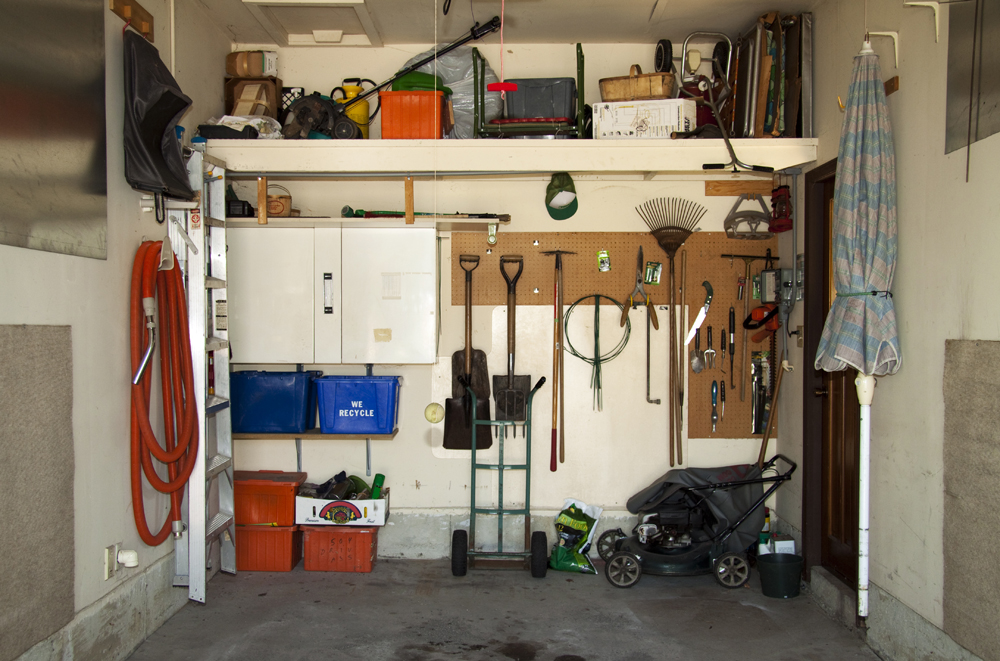 An organized garage with storage and shelving