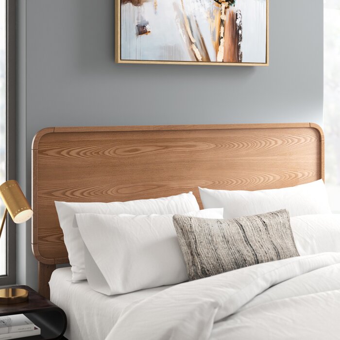 grey bedroom with solid wood headboard and white bedding