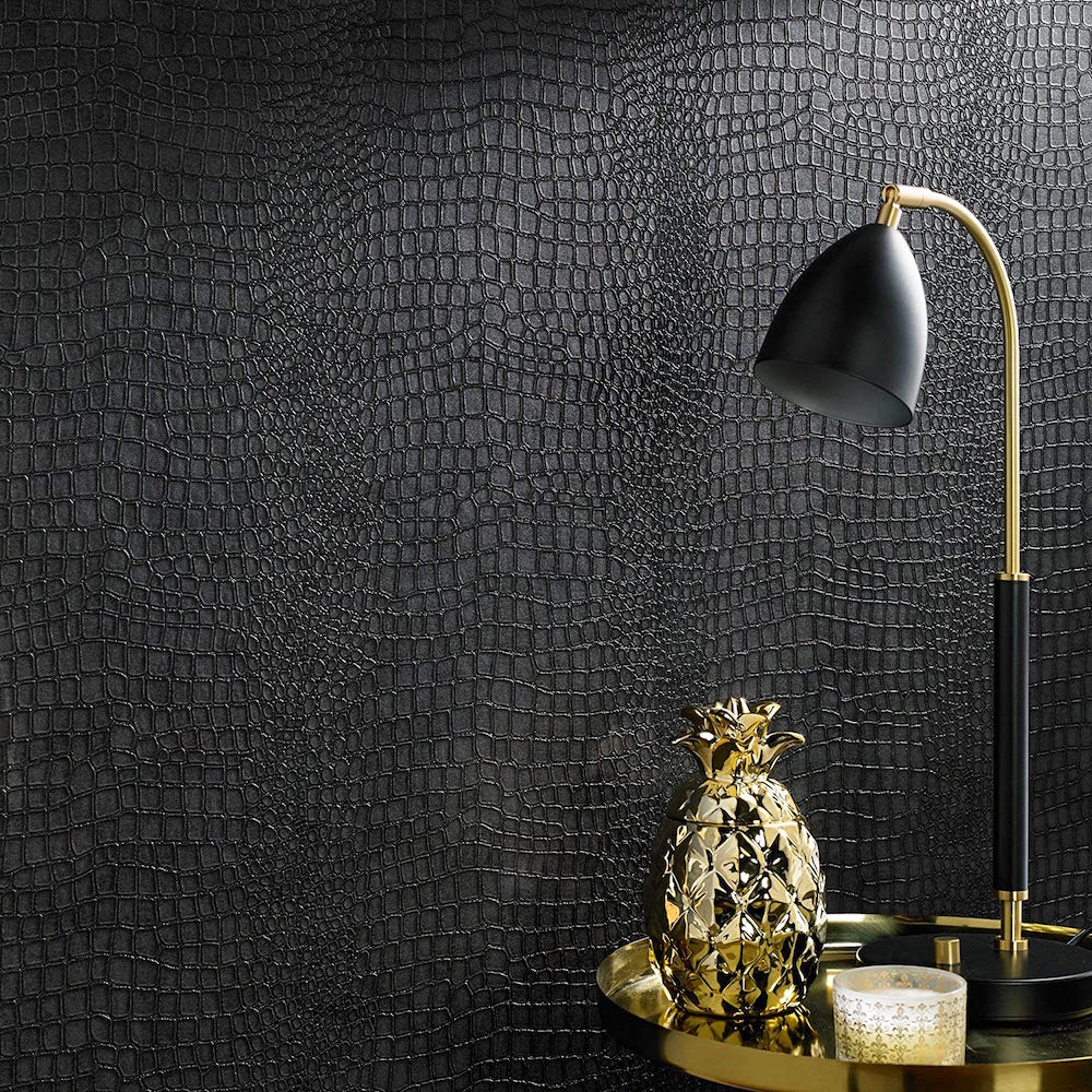 charcoal grey textured wall with gold table and accessories