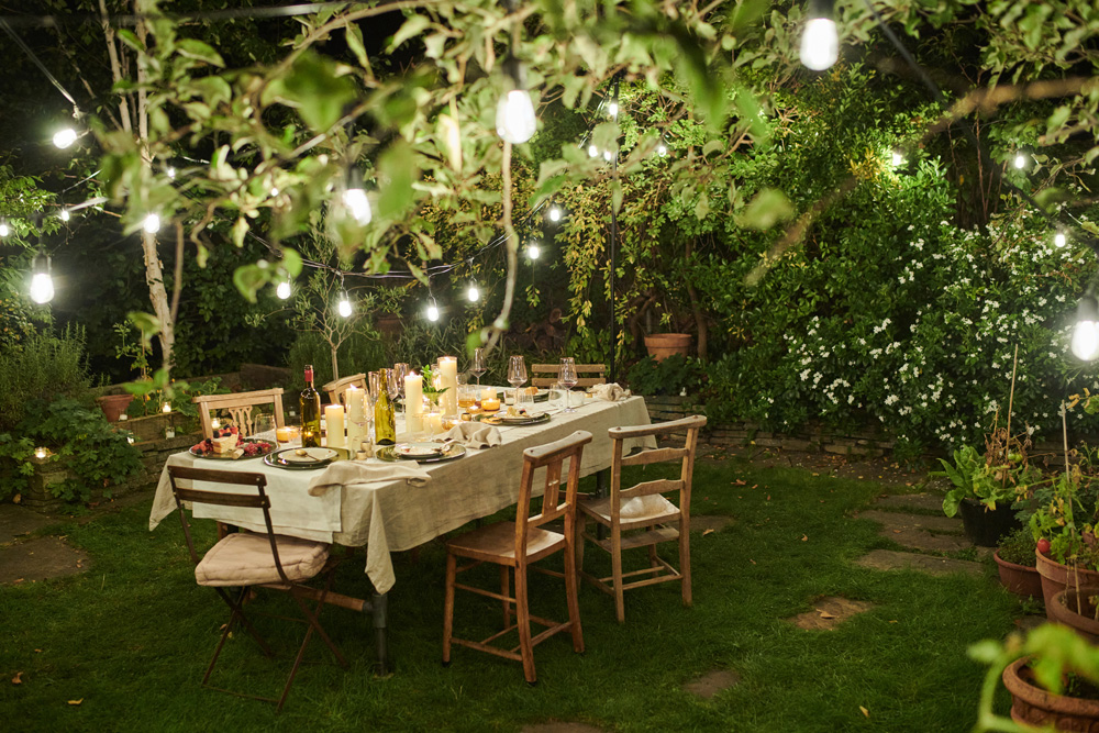 Table set in a backyard at night