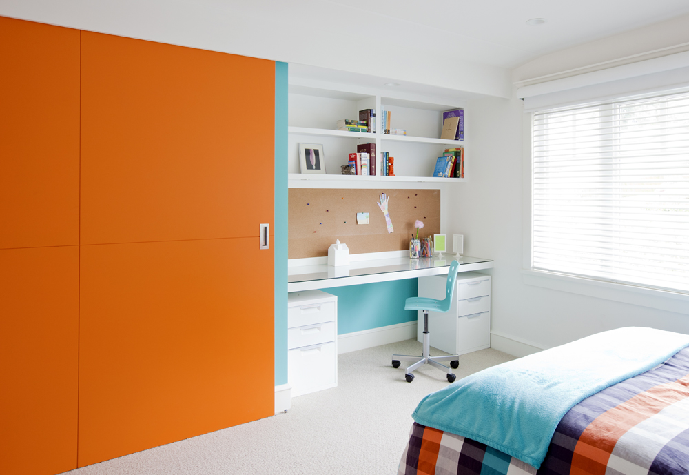 Colourful girl's bedroom with bright orange accents.