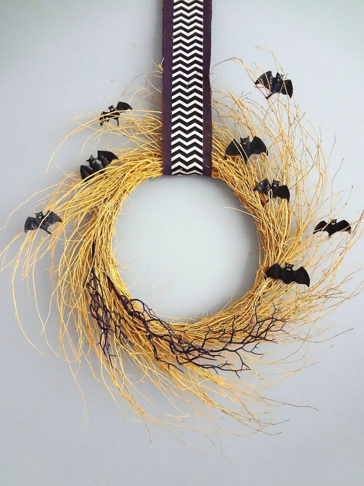 Natural-looking yellow Halloween wreath with bats