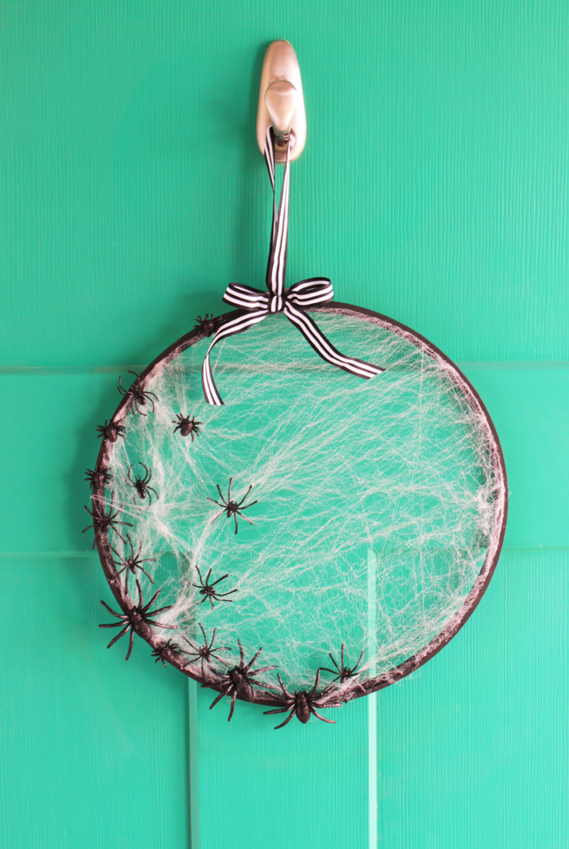 Simple DIY Halloween wreath with spiders and a web