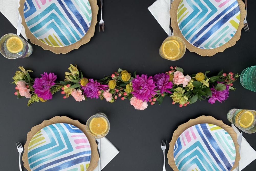 Purple and pink floral garland for an outdoor dinner party.