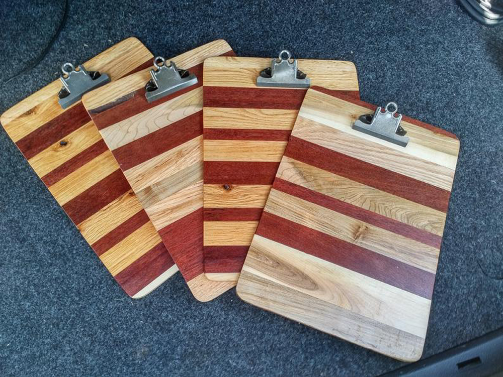 A stack of wood clipboards on a rug