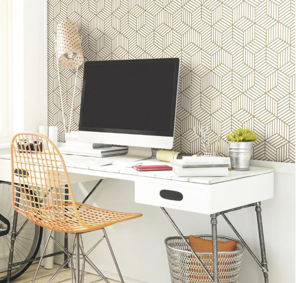 Bold, patterned removable wallpaper above a desk in a dorm room
