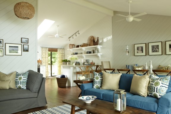 A seaside-themed cottage living room in blues, whites and natural wood colours