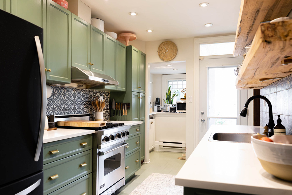 A pristine, narrow renovated kitchen in a small home