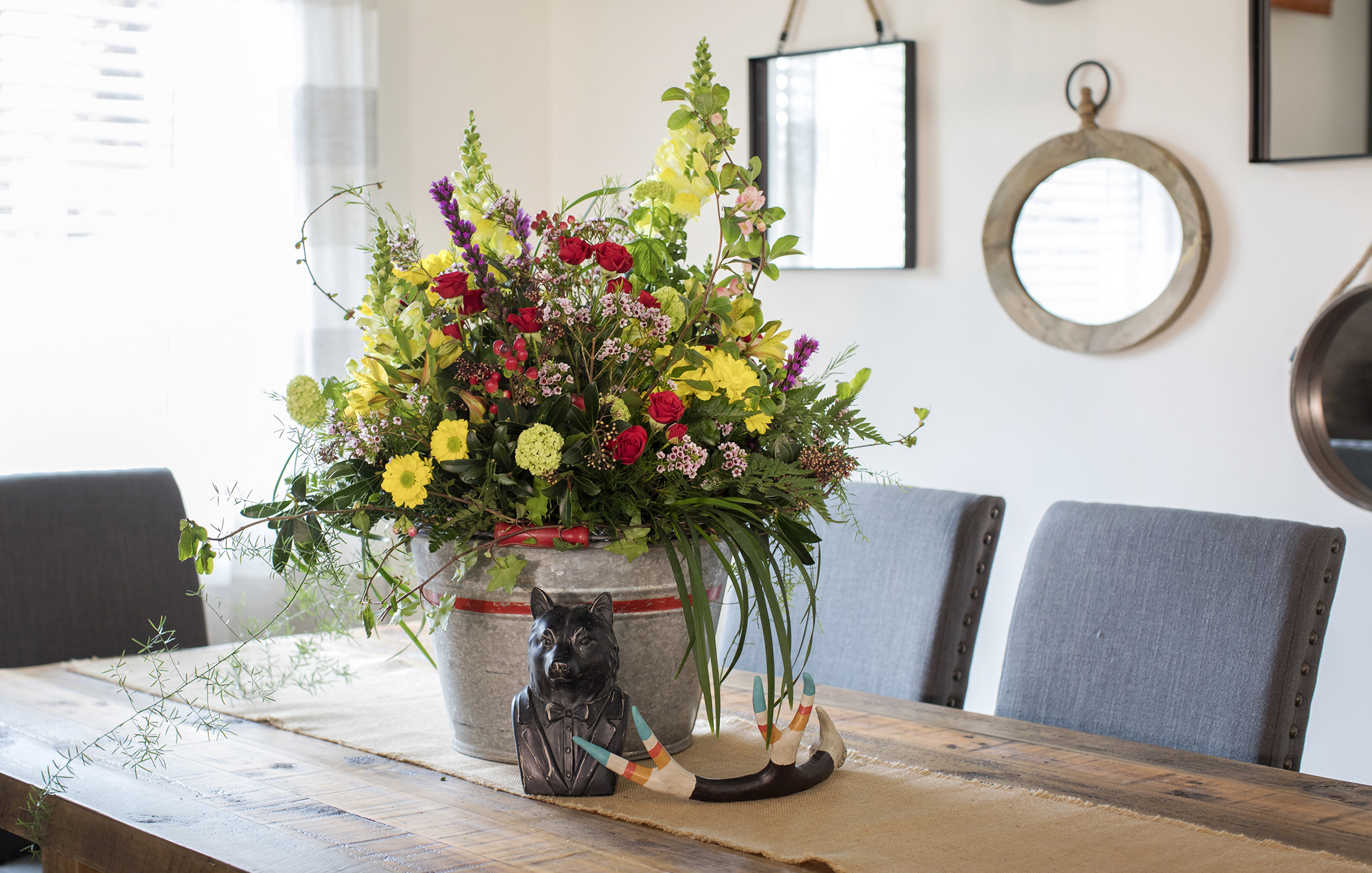 A bright bouquet is always a welcome addition to a dining-room table.