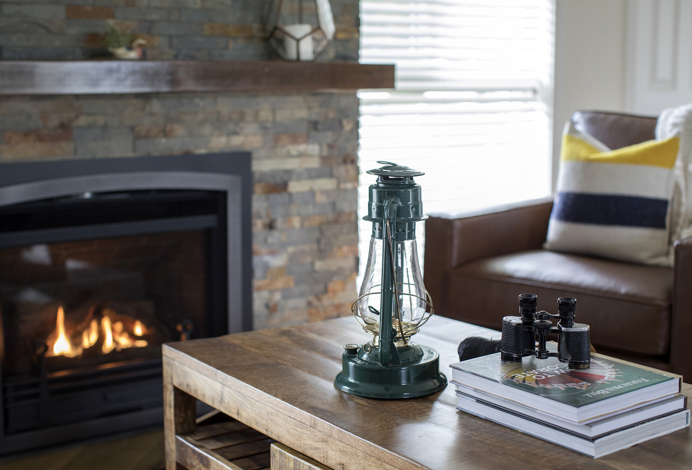 A forest green oil lamp adds to the warm, old-timey vibe of this home.