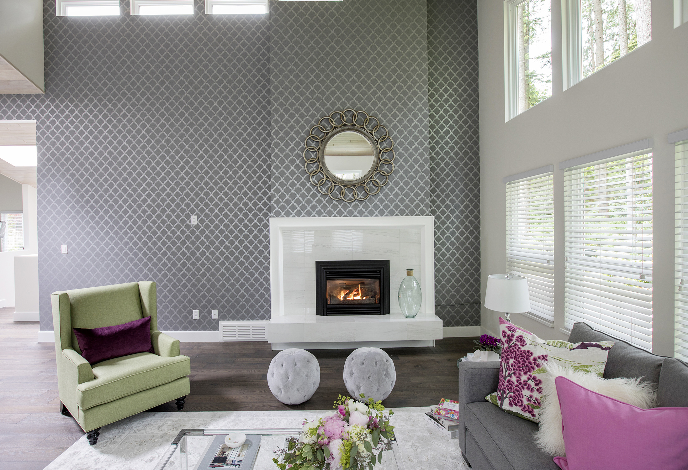 High-shine glass and white, marble-like porcelain tiles are showcased in this sleek gas fireplace.