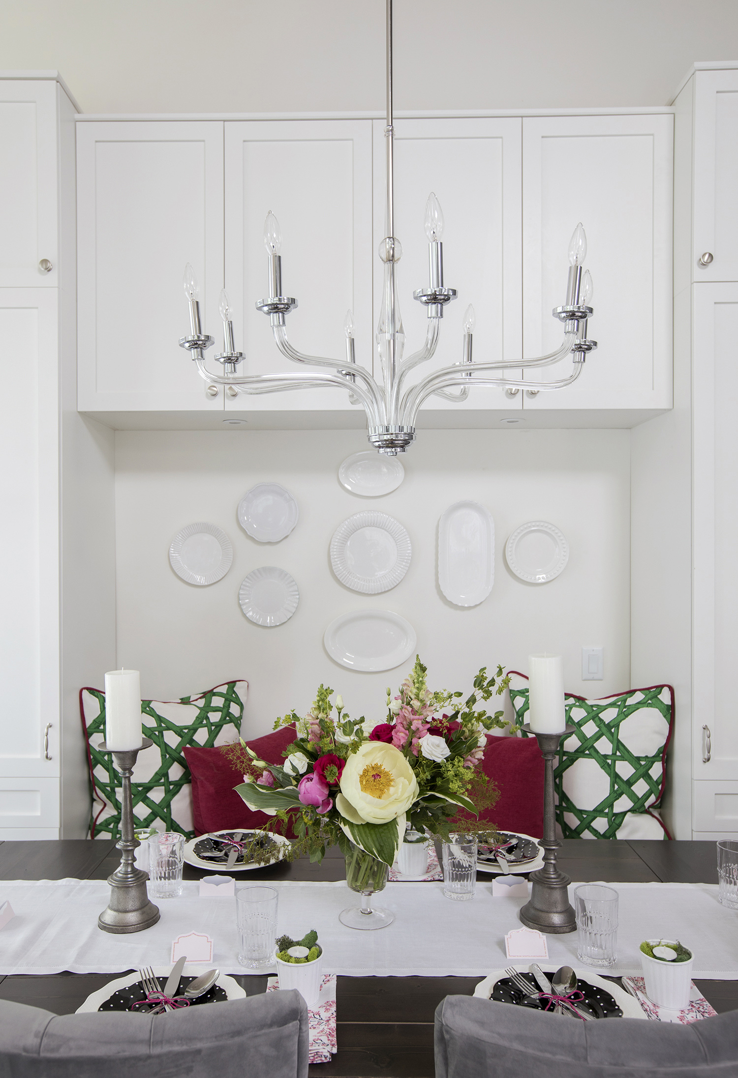 This simple glass chandelier over the dining table is a modern take on a traditional style, continuing the light and airy feel in this now contemporary home.