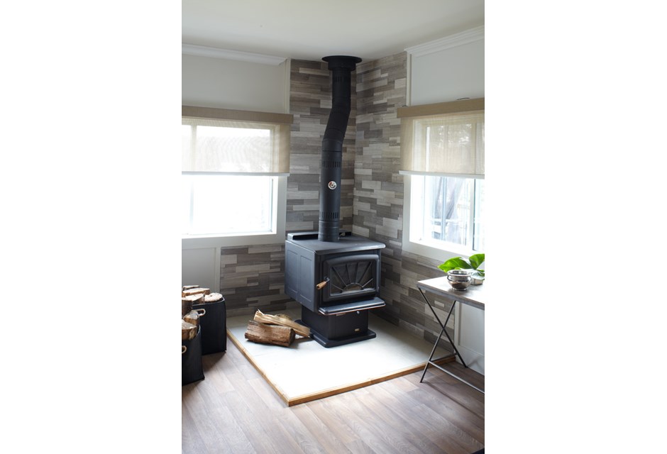 A small black fireplace in a cottage