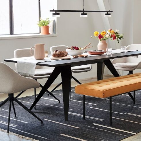 modern dining room with black table and orange bench