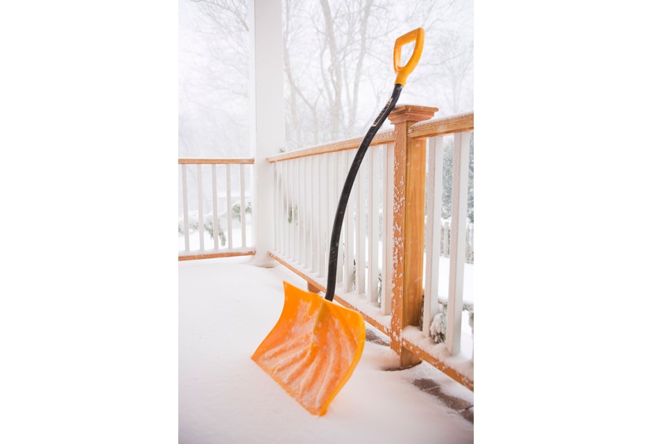 a yellow shovel outside in the snow