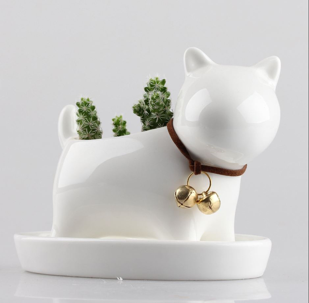 A white ceramic cat planter