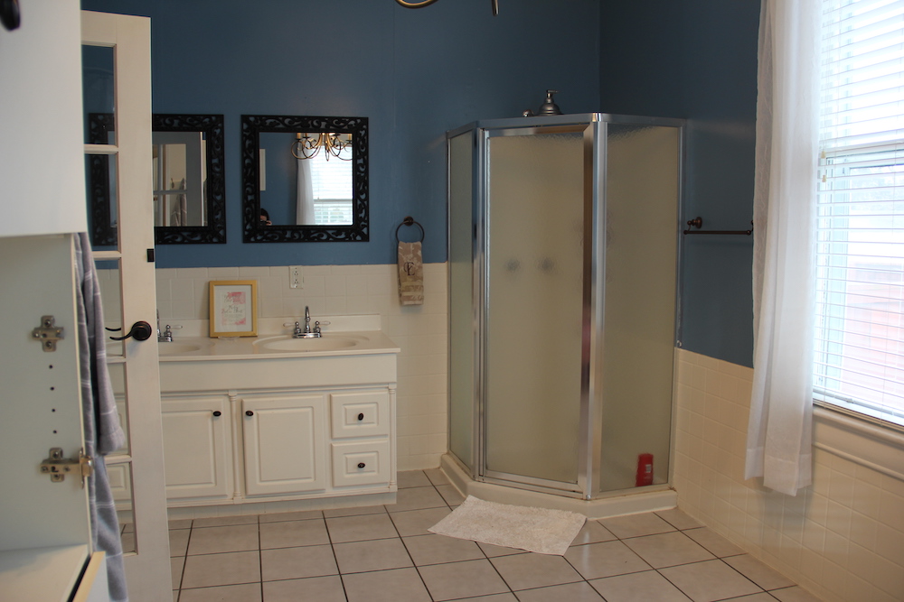 before of big bathroom with white vanity and small shower