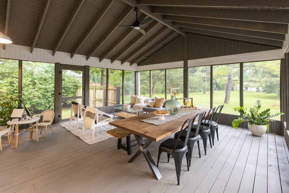 screened in porch with dining table and chairs