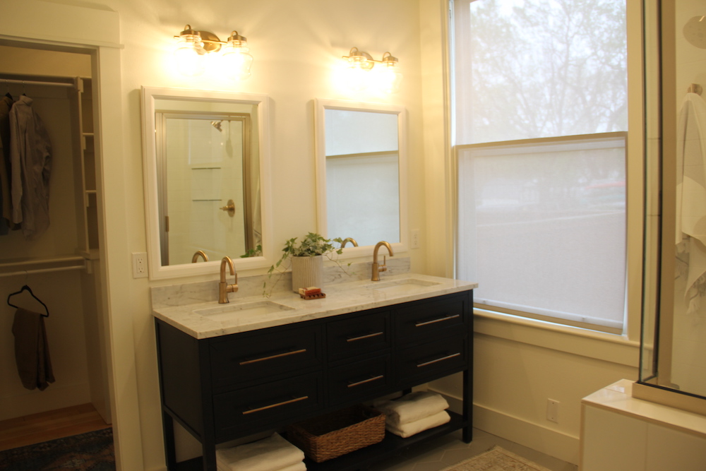 white bathroom with double vanity and two mirrors