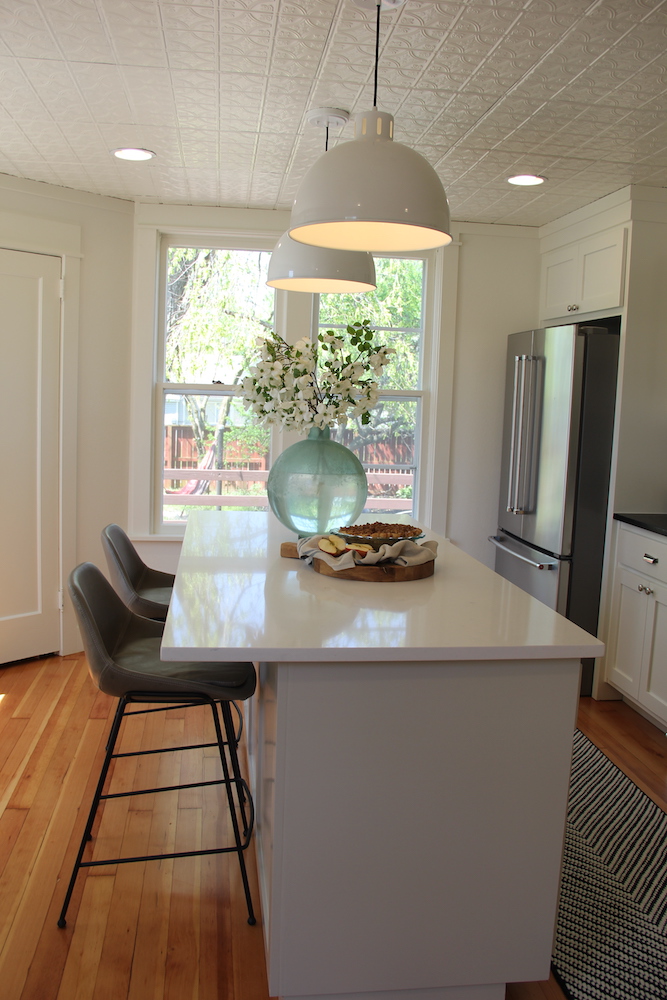 kitchen island with two white hanging lights