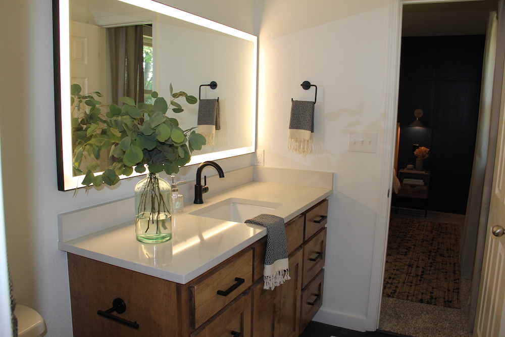 modern bathroom with wood vanity and mirror