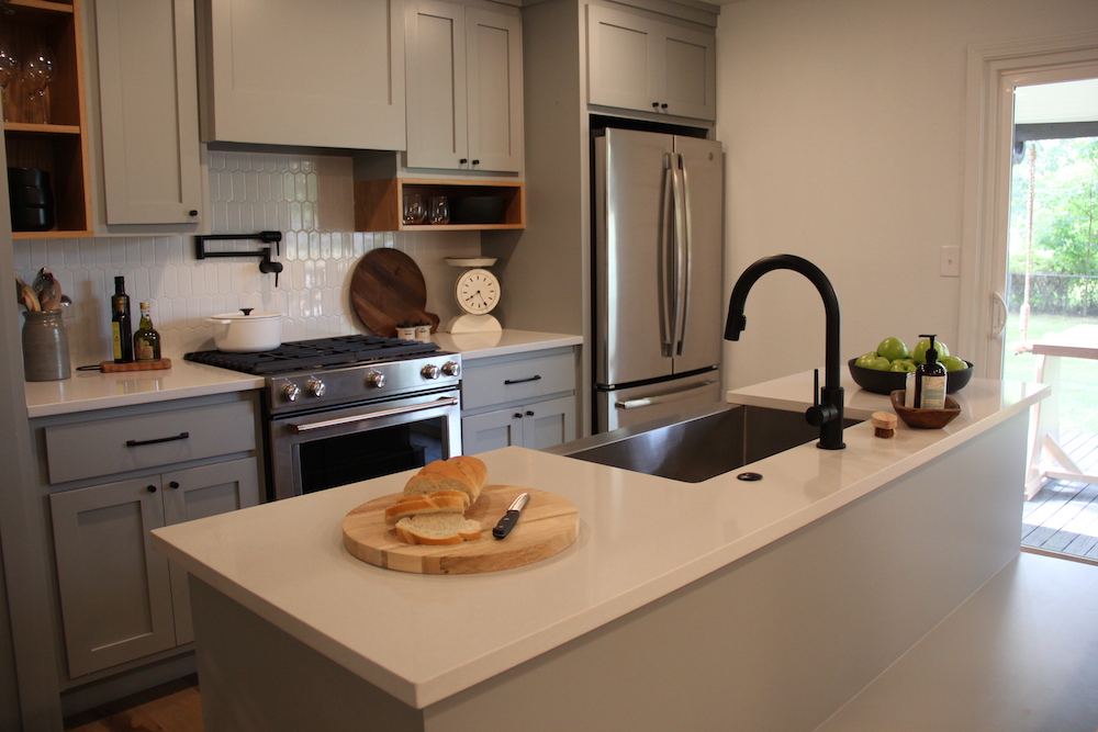 grey kitchen with sink at centre island