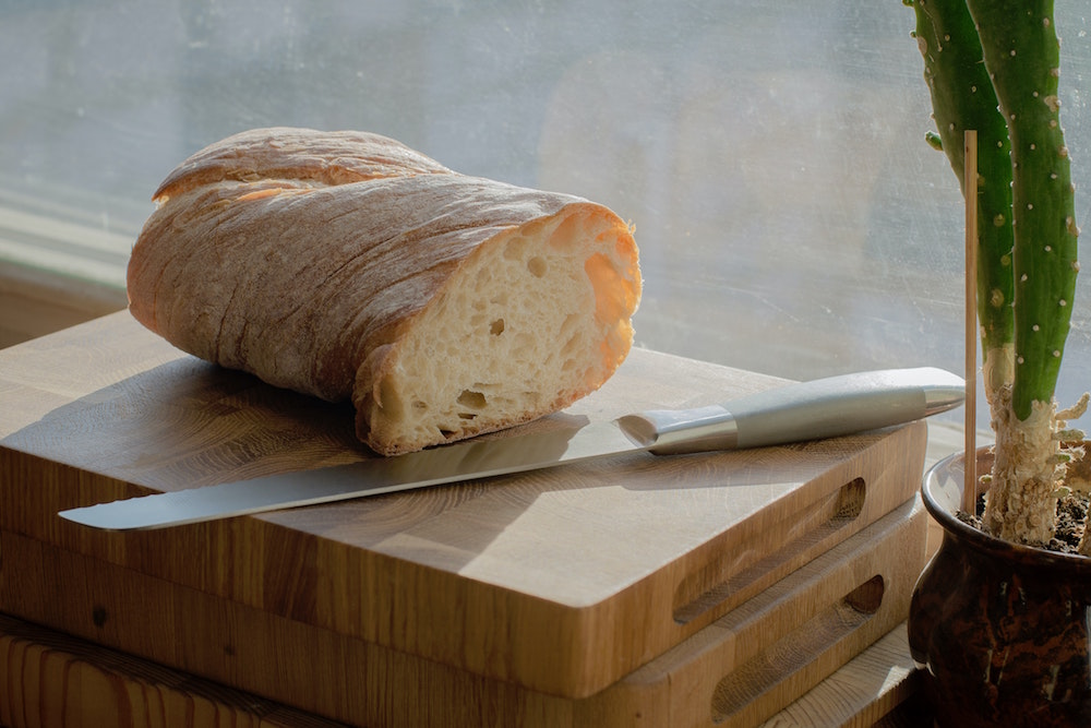 bread on cutting board with knife