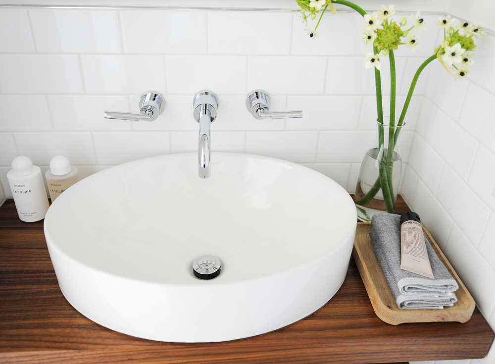 white vessel sink, two Byredo products to the left