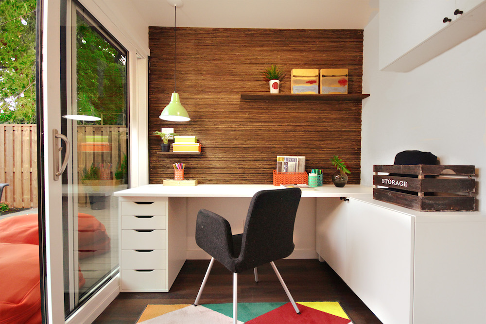 interior of shipping container office scape with wood feature wall and white desk