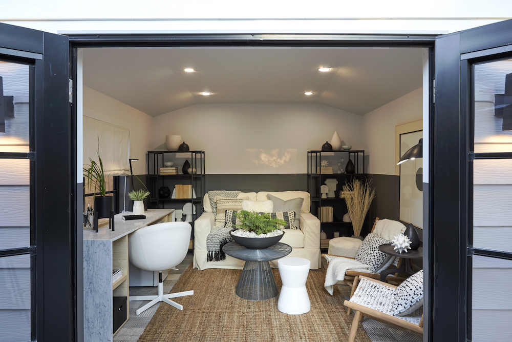 garage with white walls, desk and chair