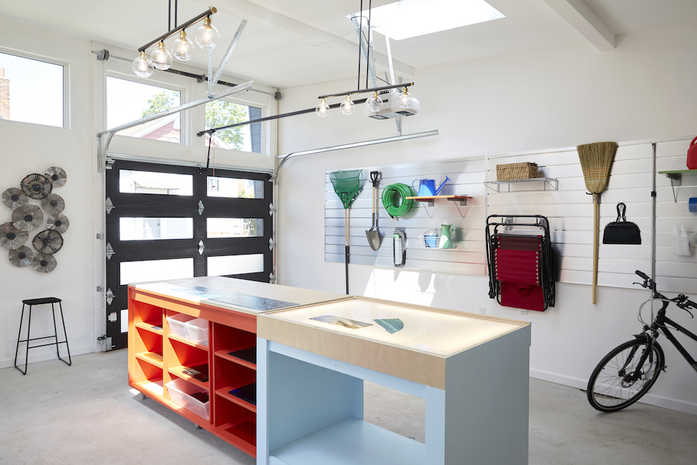 white custom workshop with skylights and hanging tool storage on wall
