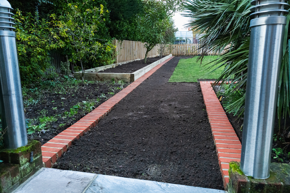 brick edging and a new garden bed edged with railway sleepers