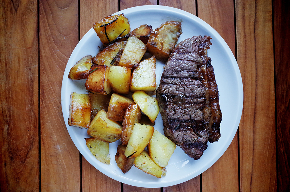 Close-Up Of Steak With Potatoes Served In Plate On Table
