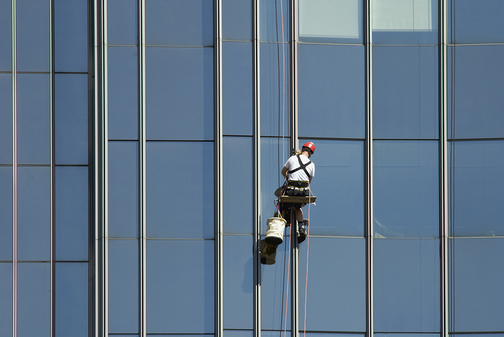 A window washing the windows of an office building