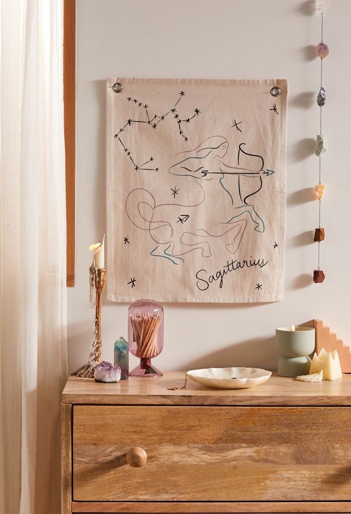 wooden dresser with sagittarius wall tapestry