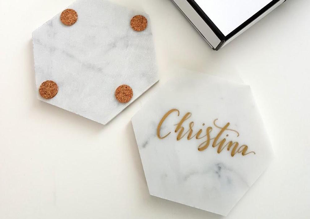 two personalized marble coasters on white background